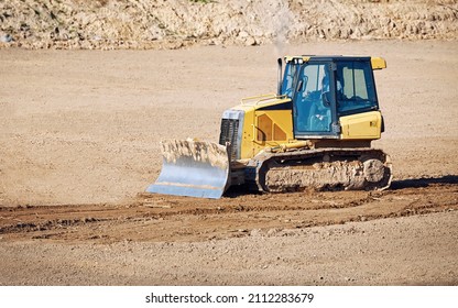 Crawler dozer with blade for leveling ground. Road construction, earthmoving on construction site. Bulldozer works. Track-Type tractor for land clearing and heavy dozing. 