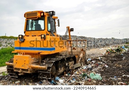 Crawler dozer working in landfill.