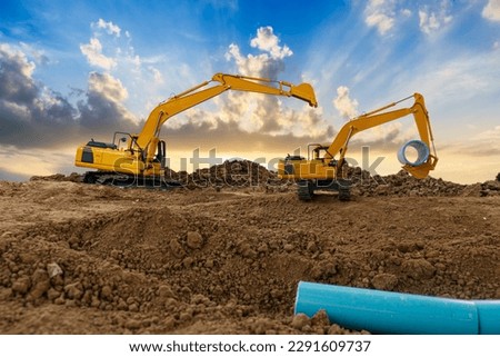 Crawler Excavator is digging in the construction site pipeline work .on area with sunbeam   backgrounds.