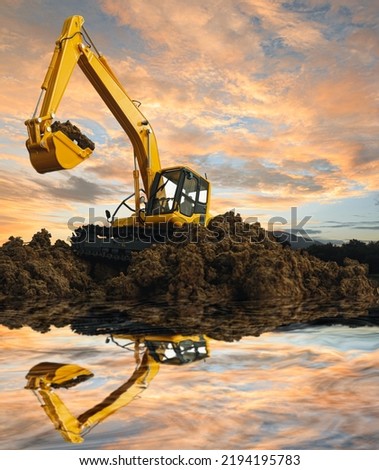 Crawler excavator is digging with lift up in the construction site  ,water reflection shadow  on sky background