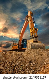 Crawler excavator during earthmoving works on construction site at sunset - Shutterstock ID 2149551157