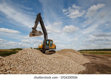 Crawler Excavator During Work. Bucket Crawler Excavator On A Summer Sky Background. Concept - Construction Equipment Services. Using A Crawler Excavator During Construction. Construction Machinery