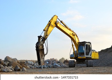 Crawler Excavator With Hydraulic Breaker Hammer For The Destruction Of Concrete And Hard Rock At The Construction Site Or Quarry.  Jackhammer Using Without Blasting Method. Hard Rock Demolition