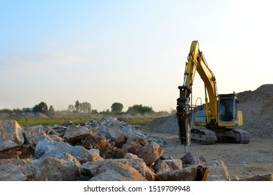 Crawler Excavator With Hydraulic Breaker Hammer For The Destruction Of Concrete And Hard Rock At The Construction Site Or Quarry.  Jackhammer Using Without Blasting Method. Hard Rock Demolition
