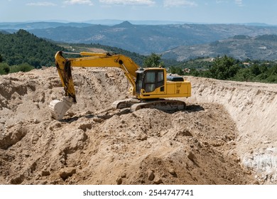 Crawler excavator working on the construction of a dam to store water for agricultural irrigation
