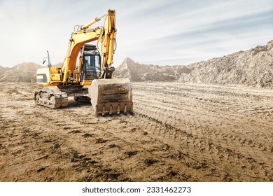 Crawler excavator works in a sand pit against the sky. Powerful earthmoving equipment. Excavation. Construction site. Rental of construction equipment - Powered by Shutterstock