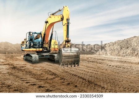Crawler excavator works in a sand pit against the sky. Powerful earthmoving equipment. Excavation. Construction site. Rental of construction equipment