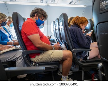 Crawley, Sussex, UK- 08.05.2020 : Passengers Onboard A Easyjet Airline Flight Which Is Compulsory To Wear Face Mask And To Board And Disembark Row By Row.