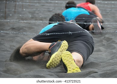 Crawling,passing Under A Barbed Wire Obstacles During Extreme Obstacle Race