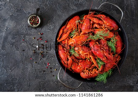 Crayfish. Red boiled crawfishes on table in rustic style, closeup. Lobster closeup. Border design. Top view. Flat lay.
