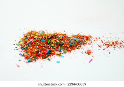 Crayon shavings on white background. Multicolored particles of colored pencils, close up, selective focus - Powered by Shutterstock