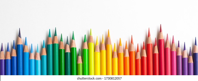 Crayons - colored pencil set loosely arranged  on white background. colored pencils are not arranged exactly in a row.
