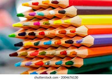 Crayons of different colors lined up on a pile