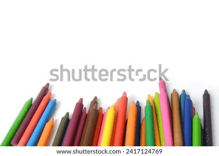 Crayons lined up isolated on white background.