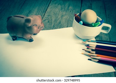 Crayons And Piggy Bank On A Sheet Of Paper,vintage Effect Filter