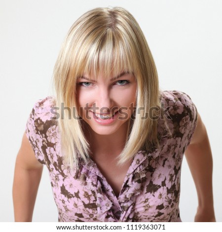 Crazy blonde woman makes squint for fun