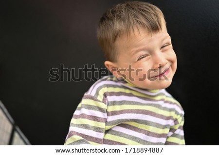 Similar – Image, Stock Photo Little cute boy looking at camera and sticking out his tongue