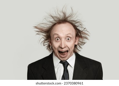 Crazy businessman worried expression. Man with hair up and opened mouth on white background - Shutterstock ID 2370380961