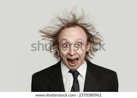 Crazy businessman worried expression. Man with hair up and opened mouth on white background