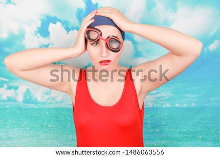 crazy diver in red swimsuit with swimming goggles on blue background. person swimmer learn to swim.