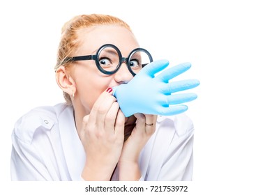 crazy doctor blows a blue glove, portrait is isolated