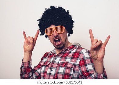 Crazy expression man in a wig and funny glasses