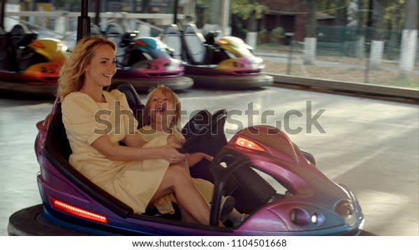 Crazy family drive on bumper\
cars