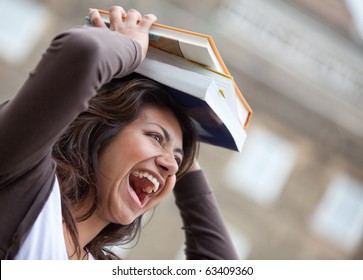 Crazy female student balancing books on top of her head