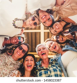 Crazy Group Of Women In Friendship Enjoying The Party In The Terrace. Large Smiles Looking Down At The Camera. Complicity And Happiness Together