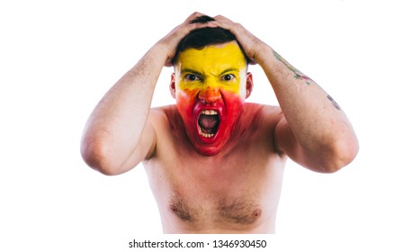 Crazy guy posing with a painted face. A bizarre portrait of a man with a painted body. Concept: sports fan, isolated on white background