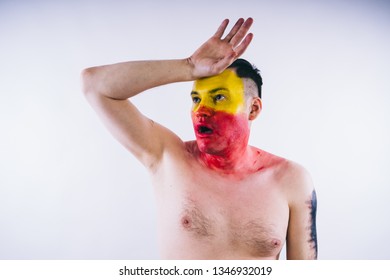 Crazy Guy Posing With A Painted Face. A Bizarre Portrait Of A Man With A Painted Body. Concept: Sports Fan