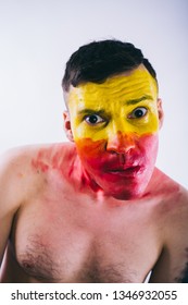 Crazy Guy Posing With A Painted Face. A Bizarre Portrait Of A Man With A Painted Body. Concept: Sports Fan