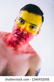 Crazy Guy Posing With A Painted Face. A Bizarre Portrait Of A Man With A Painted Body. Concept: Sports Fan