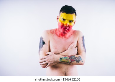 Crazy Guy Posing With A Painted Face. A Bizarre Portrait Of A Man With A Painted Body. Concept: Sports Fan