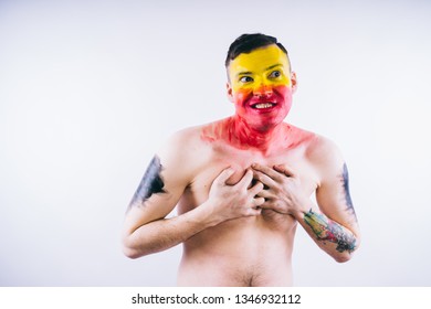 Crazy Guy Posing With A Painted Face. A Bizarre Portrait Of A Man With A Painted Body. Concept: Sports Fan