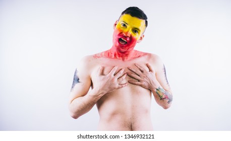 Crazy Guy Posing With A Painted Face. A Bizarre Portrait Of A Man With A Painted Body. Concept: Sports Fan