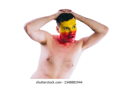 Crazy Guy Posing With A Painted Face. A Bizarre Portrait Of A Man With A Painted Body. Concept: Sports Fan, Isolated On White Background