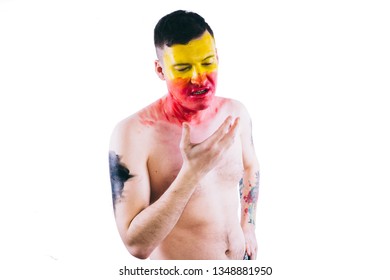 Crazy Guy Posing With A Painted Face. A Bizarre Portrait Of A Man With A Painted Body. Concept: Sports Fan, Isolated On White Background