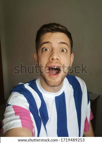 Crazy guy taking a self portrait indoor at home