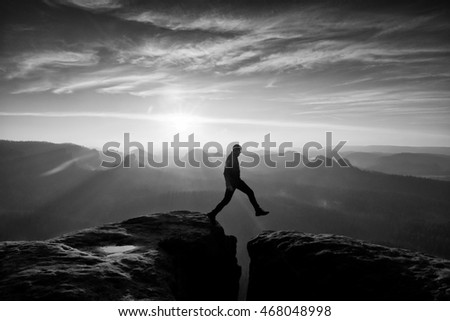 Similar – photographer in mountain at sunset