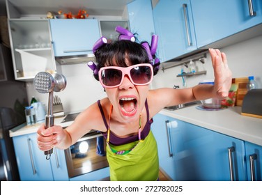 Crazy Housewife In An Interior Of The Kitchen. Family Problems.