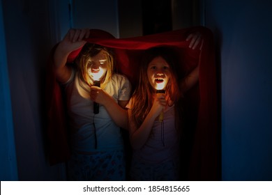 Crazy Kids Under A Blanket With Flashlights, Scary Stories And Horror Stories, Kids Scare For Halloween.