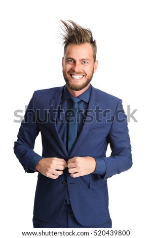 Crazy looking businessman in a blue suit and tie, smiling towards camera. White background.