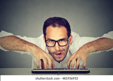 Crazy looking nerdy man typing on the keyboard