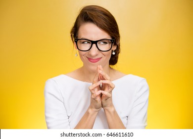 crazy looking sly woman in black glasses isolated on yellow background.