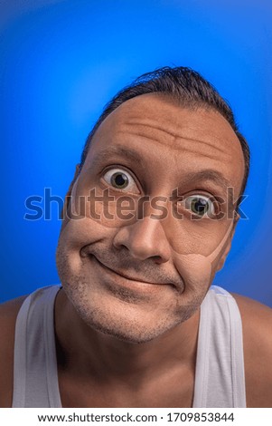 Crazy man with googly eyes with traces of a medical mask. New Corona virus , COVID-19, or 2019-ncov infection (novel corona virus disease) idea. Stay at home Pandemic concept.