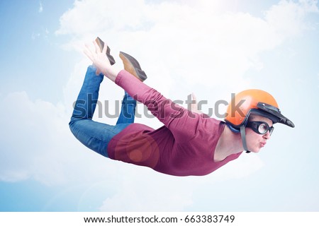 Crazy man in red helmet and goggles is flying in the sky. Jumper concept