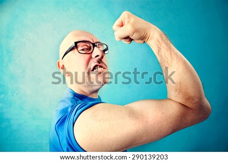 crazy man showing  proudly  its muscles