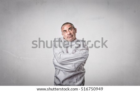 crazy man with straitjacket looking up