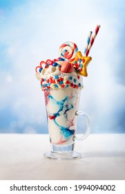 Crazy Milk Shake With Ice Cream,whipped Cream, Marshmallow,cookies And Colored Candy In Glass. Sweet Dessert For Fourth Of July. Idea Milkshake For Patriotic Day.